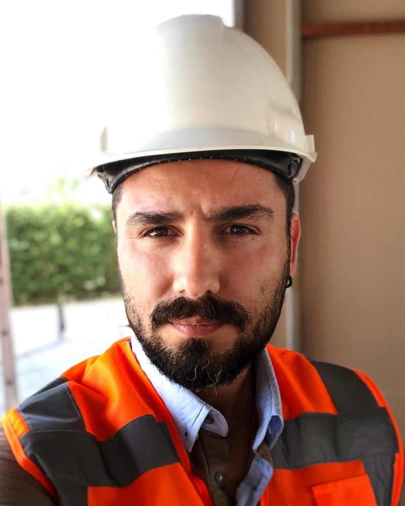 Gökhan Ünsel on site in a hard hat